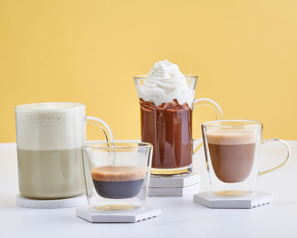 cappuccino-hot-chocolate-with-cream-and-coffee-served-in-glasses-SPM-1000x800