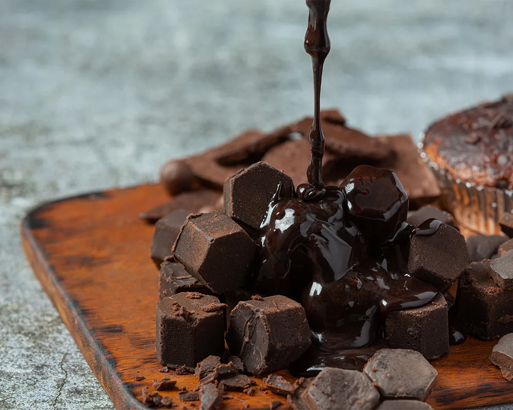 Chocolate-shapes-on-a-cutting-board-with-chocolate-icing-dripping-on-top-SPM-1000x800